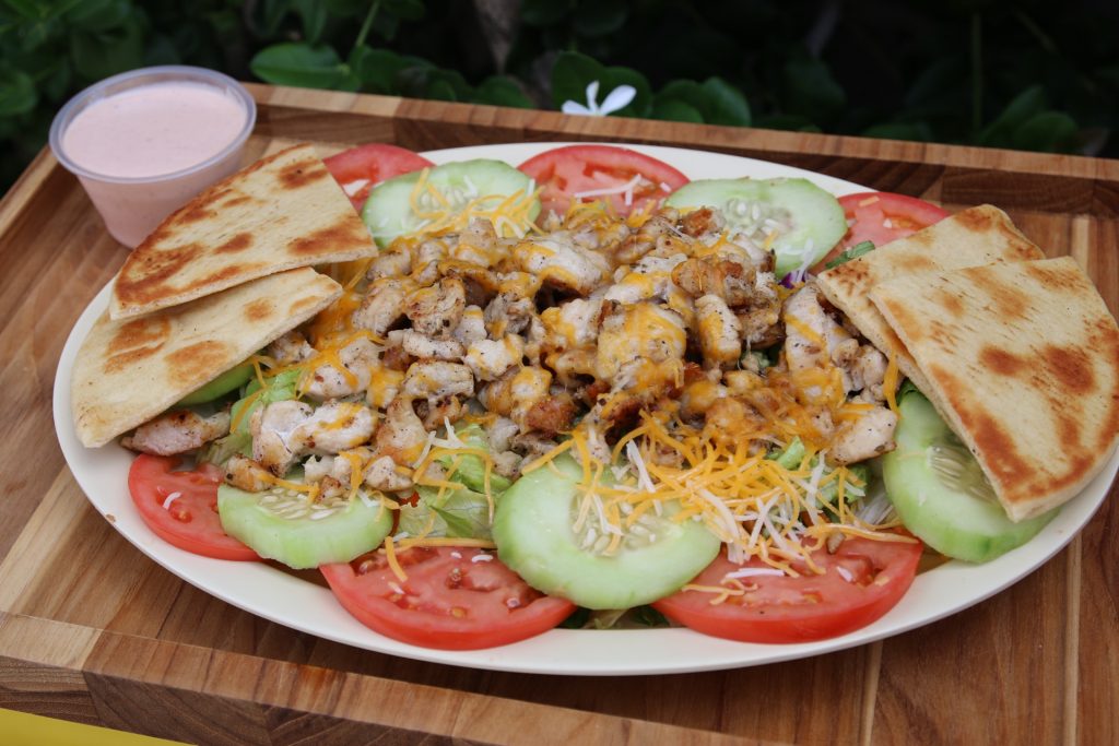 Grilled chicken salad with cheese, tomato, cucumber, pita bread and dressing