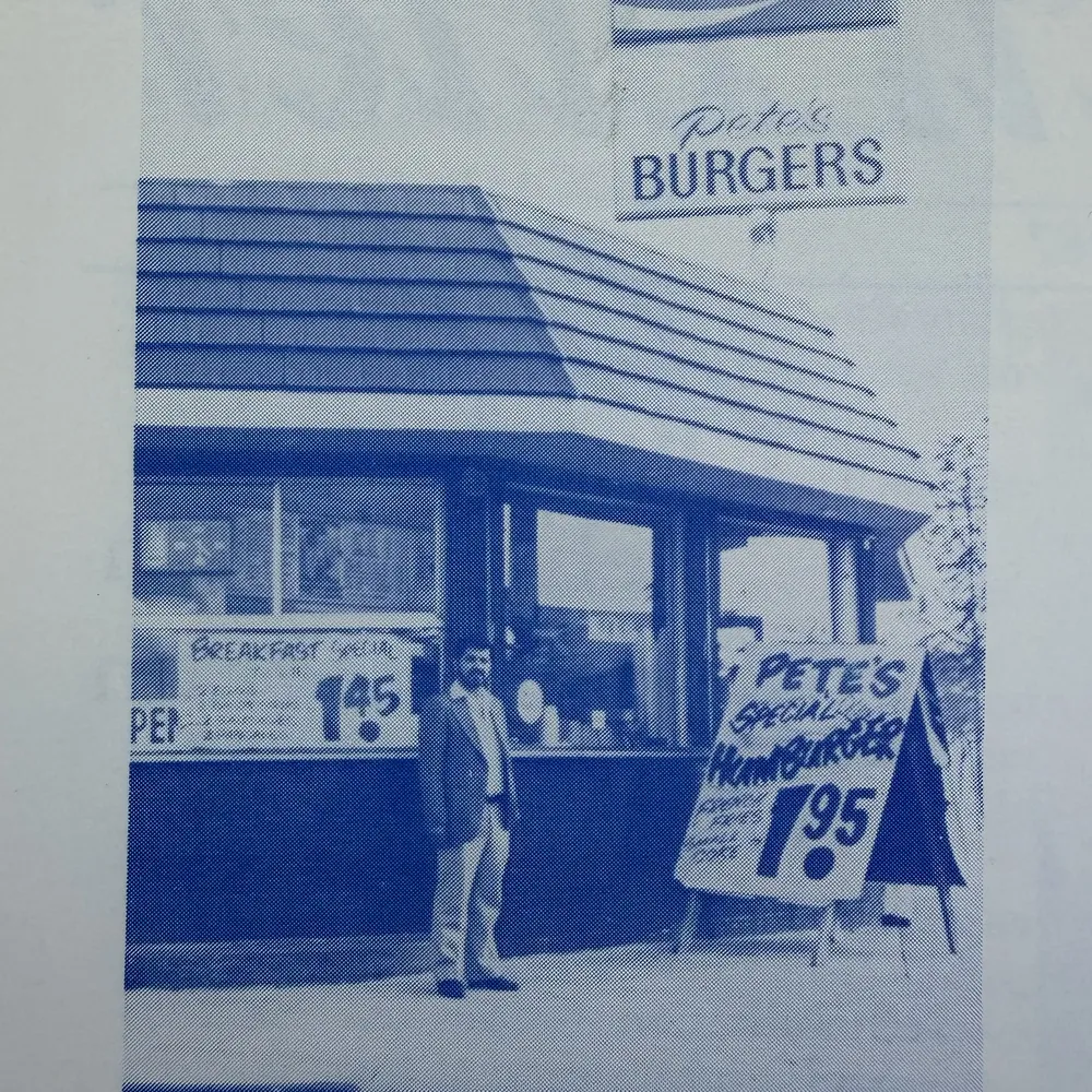 Vintage blue print of Pete Zinelis outside the original Pete's Burgers
